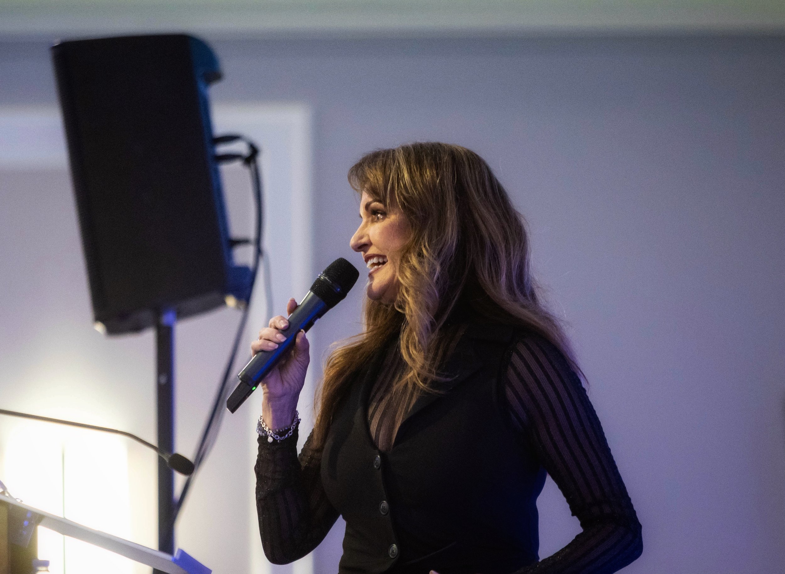 Bonnie speaking into microphone and smiling